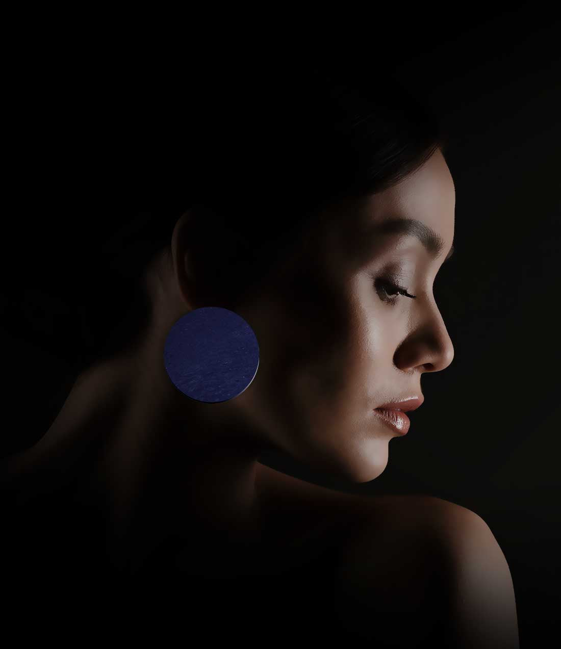 Femme qui porte boucles d’oreilles Circle en liège bleu de la marque Paola Borde